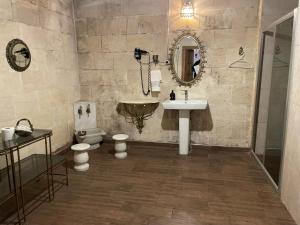 a bathroom with a sink and a toilet and a mirror at aynur hanım konağı butik otel in Şahinbey