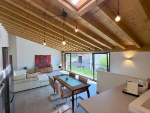 a large living room with a table and chairs at B&Bike la vetrata sui vigneti in Stazione di Bornato-Calino +54 photos