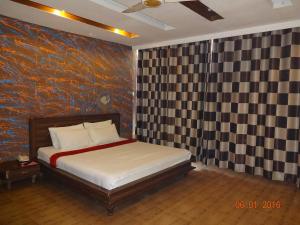 a bedroom with a bed and a painting on the wall at Premier Inn Davis Road Lahore in Lahore