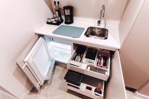 a small kitchen with a counter and a sink at Estrella De Mar - Boutique ApartHotel in Benidorm +22 photos