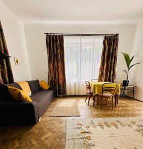 a living room with a couch and a table at Spacious Garden Villa in Lublin