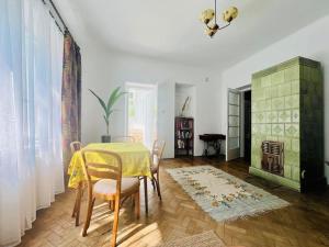 a dining room with a yellow table and chairs at Spacious Garden Villa in Lublin