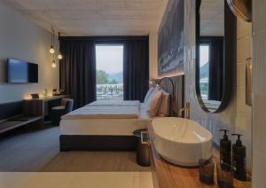 Postel nebo postele na pokoji v ubytování Dorint Resort & Spa Locarno-Riazzino - New Opening