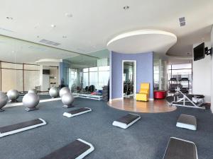 a gym with pilates equipment in a building at Mercure Padang in Padang
