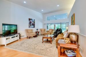 a living room with a couch and a tv at 4 Mi to UGA Pet-Friendly Home in Athens in Athens