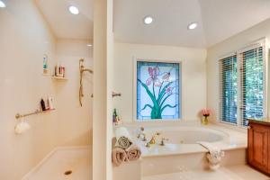 a bathroom with a tub and a window at 4 Mi to UGA Pet-Friendly Home in Athens in Athens +32 photos