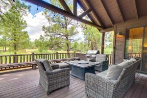 una veranda protetta con sedie e un tavolo di Spacious Torreon Cabin with Deck and Gas Grill! a Show Low