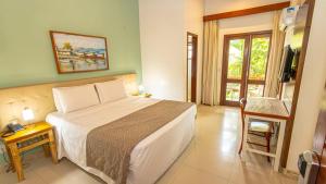 Postel nebo postele na pokoji v ubytování Enseada dos Corais Praia Hotel + 35 fotografií