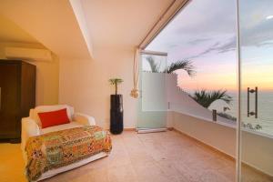 a bedroom with a view of the ocean from a window at Two-Story Beachfront Oasis in Puerto Vallarta
