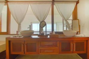 a bathroom with two sinks on a wooden dresser at Two-Story Beachfront Oasis in Puerto Vallarta +33 photos