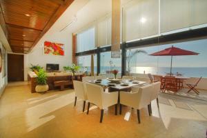 a dining room with a table and chairs at Two-Story Beachfront Oasis in Puerto Vallarta