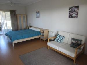 a bedroom with a bed and a couch at Flour Cask Bay Retreat in Haines
