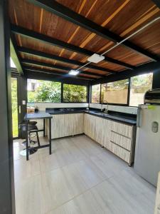 a large kitchen with a table and a refrigerator at Los Bambúes in El Peñol