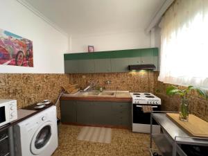 a kitchen with a sink and a washing machine at Spacious Artistic Flat With Private Parking in Thessaloniki +7 photos