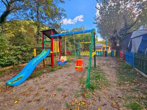 a playground with a slide in a yard at Camping Ribera del Ara in Fiscal