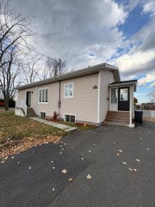 a white house with a porch and a driveway at Maison d edouard in Saint-Antonin