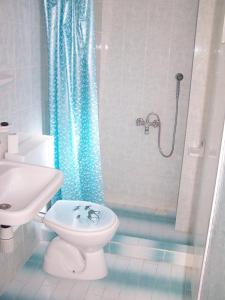 a bathroom with a toilet and a shower at Villa Fortin Pension in Kuşadası +47 photos