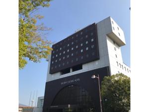 a tall building with a sign in front of it at Recent Culture Hotel - Vacation STAY 29737v in Okayama +3 photos