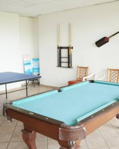 a pool table in a room with two tables at Ocean View Yuké Studio in Luquillo