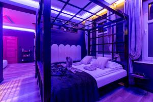 a bedroom with a bunk bed in a purple room at Secret Love BDSM & SPA in Poznań