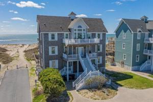 an aerial view of a large house on the beach at 8 Bed Oceanfront in OBX with Pool & Hot Tub in Frisco
