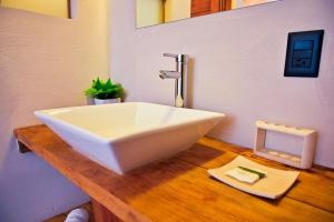 a bathroom with a large white sink on a wooden counter at Villa Maria Hotel in Valle de Bravo