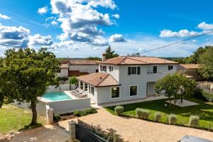 a villa with a swimming pool and a house at Villa Paronich in Barban