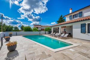 a swimming pool in the backyard of a house at Villa Paronich in Barban