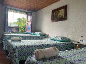 Postel nebo postele na pokoji v ubytování Finca Hotel San Cristobal Quindio