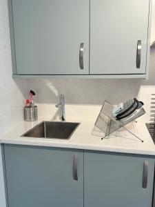 a kitchen counter top with a sink and a counter at The Warehouse Apartments, 1 - Bed, Sleeps 2, Ulverston - UK in Ulverston