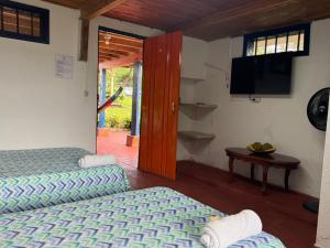 Postel nebo postele na pokoji v ubytování Finca Hotel San Cristobal Quindio