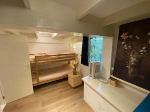a small bedroom with a bunk bed and a television at 't Grote Egeltje XL chalet 220 in Durbuy +56 photos
