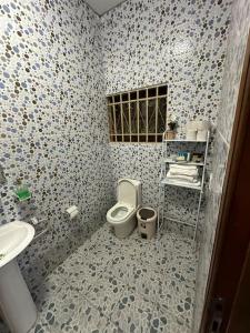 a bathroom with a toilet and a sink at Amc Luxe Retreat in Amasaman +5 photos
