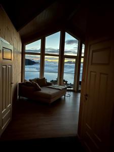 a living room with a couch and large windows at Susans Hus in Vradal +18 photos