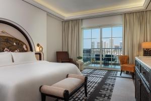 a hotel room with a bed and a large window at The Westin Dubai Mina Seyahi Beach Resort and Waterpark in Dubai
