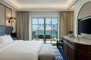 a hotel room with a bed and a flat screen tv at The Westin Dubai Mina Seyahi Beach Resort and Waterpark in Dubai