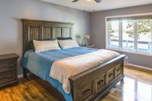 a bedroom with a large bed and a window at Lakefront Arkansas Escape with Grill, Dock and Kayaks! in Horseshoe Bend