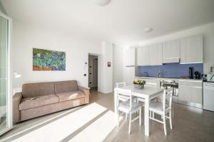 a living room with a couch and a table at Lake Como View - Casa La Rosa in Abbadia Lariana