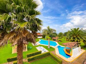 an image of a villa with a swimming pool at Hotel Rancho Las Margaritas in Valle de Bravo