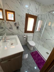 a bathroom with a sink and a toilet and a shower at Apartaments Turístics LA FONTETA in Cardona +29 photos