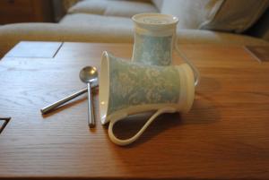 a tea pot on a table with a spoon at Kenilworth Guest House in Windermere