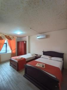 Postel nebo postele na pokoji v ubytování Hotel Quezada Hermanos