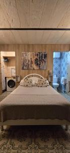 a bedroom with a large bed in a room at Servants' Quarters Studio Apartment in Valletta +6 photos