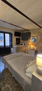 a bedroom with a large bed in a room at Servants' Quarters Studio Apartment in Valletta