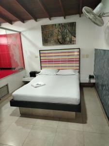 Postel nebo postele na pokoji v ubytování Hotel Medellin Park