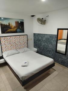 Postel nebo postele na pokoji v ubytování Hotel Medellin Park