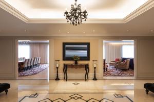 a living room with a chandelier and a table at The Westin Dubai Mina Seyahi Beach Resort and Waterpark in Dubai