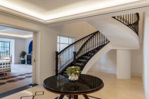 a staircase in a house with a table and flowers at The Westin Dubai Mina Seyahi Beach Resort and Waterpark in Dubai