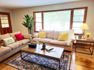 a living room with a couch and a coffee table at Charming Retreat in the heart of Burlington in Burlington