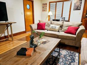a living room with a couch and a coffee table at Charming Retreat in the heart of Burlington in Burlington